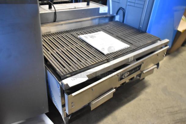 Brand new EmberGlo stainless steel countertop electric charbroiler grill, 208/480V, 1 phase, minor scratches and dents visible.
