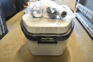 BRAND NEW Liberty Pumps 406 Compact Automatic Drain Pump, 1/6 hp, 115V, with float switch. Slight scratches; includes fittings.