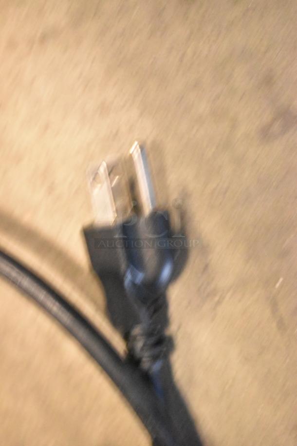 Blurry photo of a power plug for the Robot Coupe CL50 food processor, 120 volts, indicating electrical compatibility.