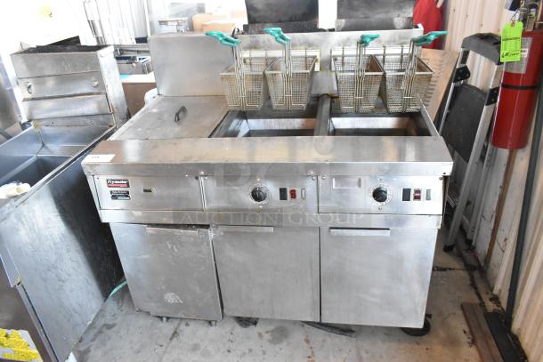 Frymaster FM245ESC stainless steel 2-bay deep fat fryer with dumping station, 4 metal baskets, on casters, 122,000 BTU.