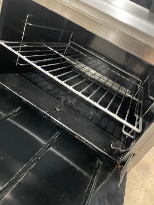 Therma Tek commercial stainless steel 10-burner range with double oven. Includes backsplash and wired oven racks. On casters.