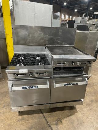 Imperial commercial stainless steel range with 4 burners, raised flat griddle, double oven, broiler, backsplash, and wired racks.