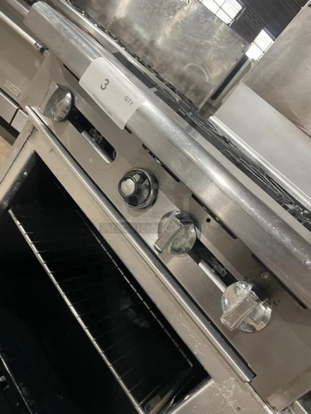 Imperial commercial stainless steel gas range with 4 burners, raised griddle, double oven, broiler, and wired racks.