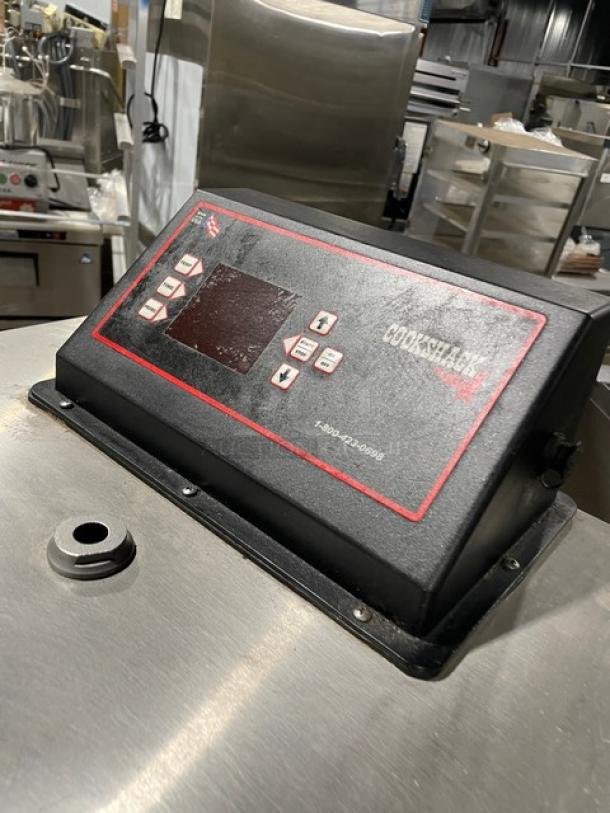 Cookshack SM066 commercial stainless steel electric smoker oven, digital controls, wired rack, enclosed base, on casters.