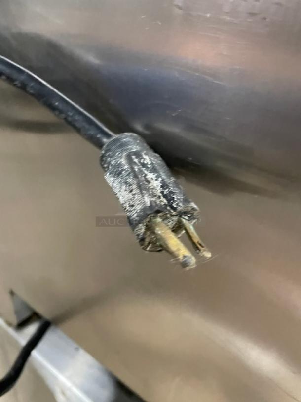 Cookshack SM066 commercial smoker oven plug, showing wear, for 120V connection.