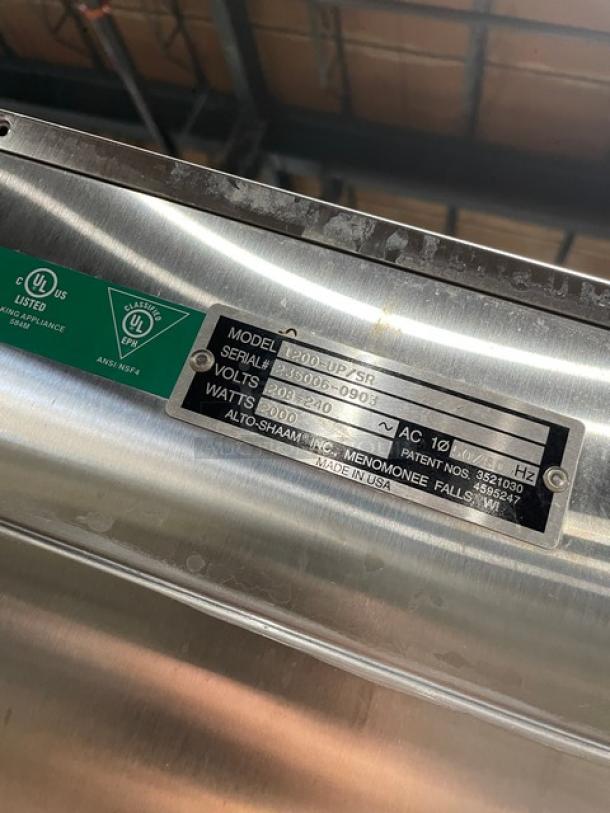 Alto-Shaam 1200UPSR stainless steel heated holding cabinet label, featuring model 1200-UP/SR, SN 235006-0903, 208-240V specs.