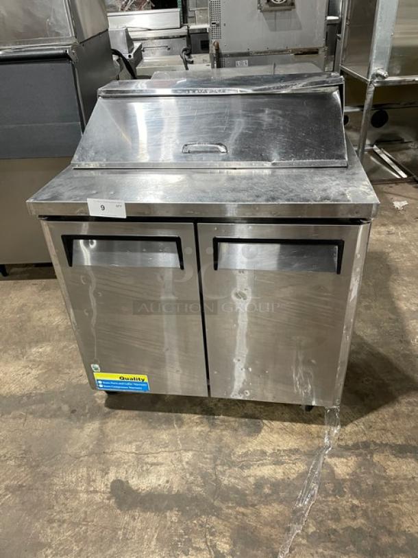 Turbo Air MST-36 stainless steel 2-door refrigerated prep table with poly-coated rack, on casters, 115V, visible wear.