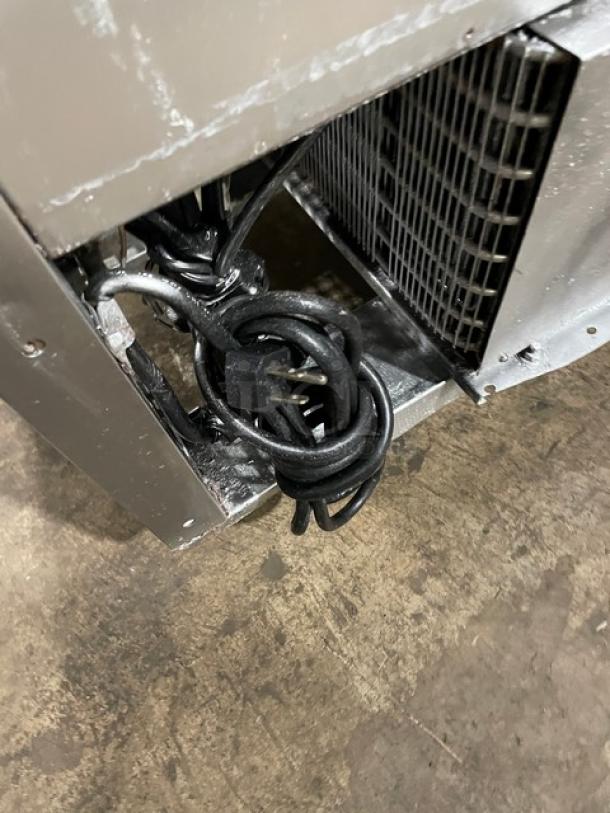 Rear view of Turbo Air MST-36 refrigerated prep table power cord and ventilation grille, showcasing stainless steel construction.