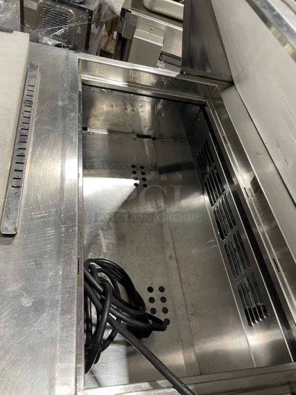 Everest EPBNR1 stainless steel refrigerated bain marie prep table with cutting board, 2 drawers, 115V, on casters.