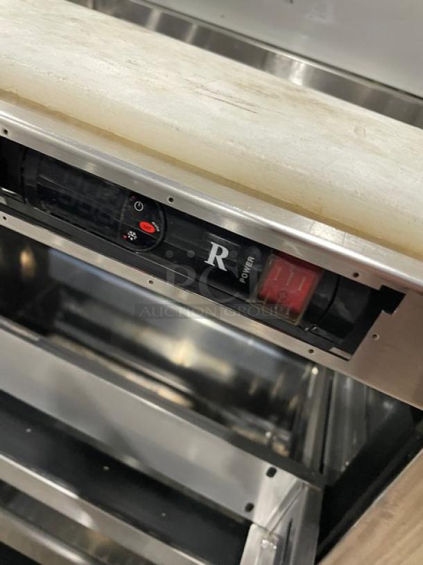 Everest EPBNR1 stainless steel refrigerated prep table with two drawers, cutting board, control panel, and casters.