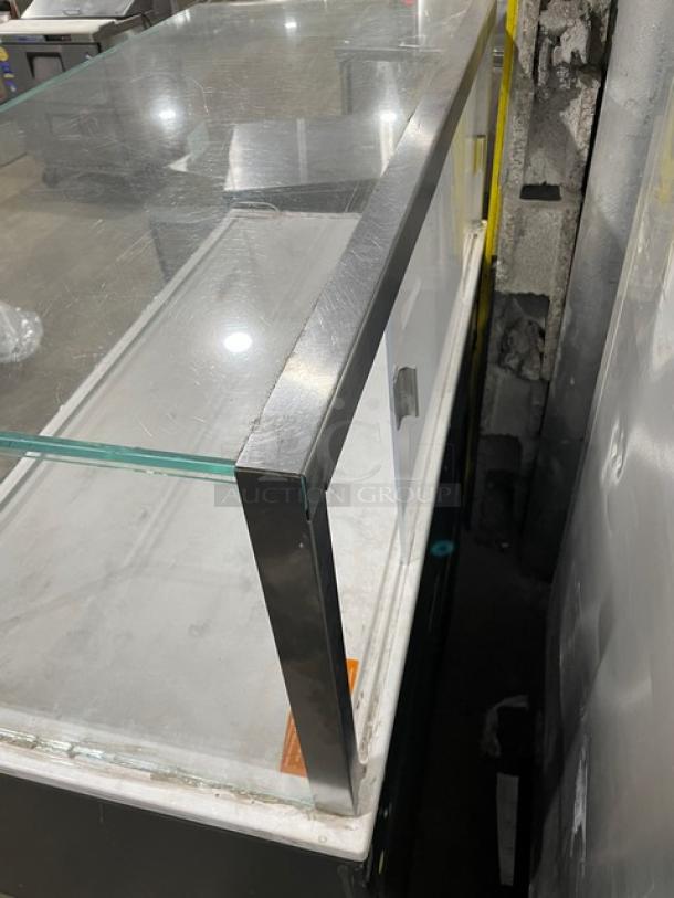 Structural Concepts commercial black multi-level refrigerated display case with upper enclosed-glass showcase, on legs.