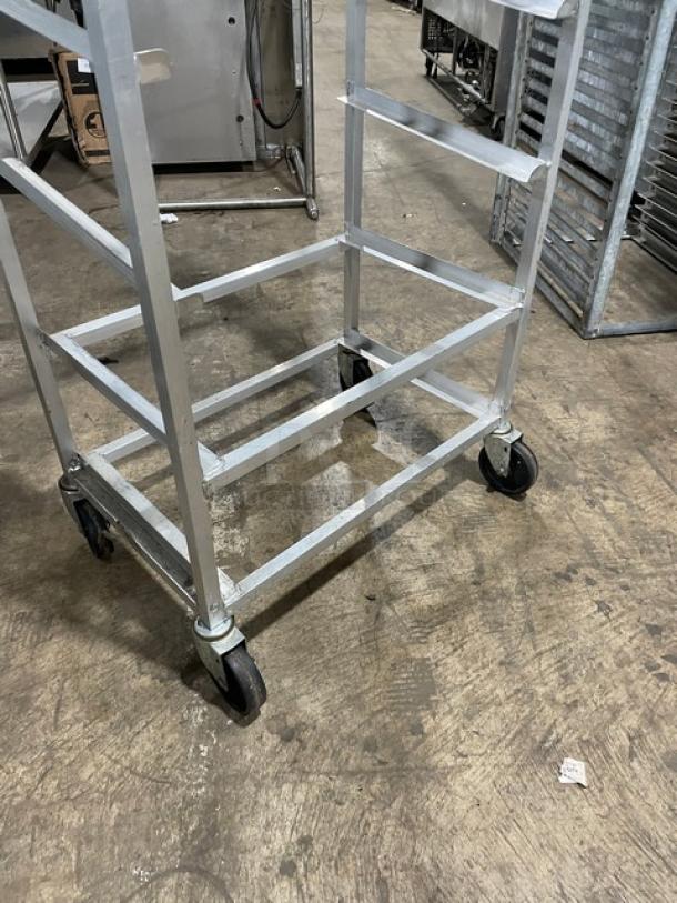 Channel SRS-7 aluminum slanted display rack on casters, commercial-grade, sturdy, good condition, ideal for easy mobility.