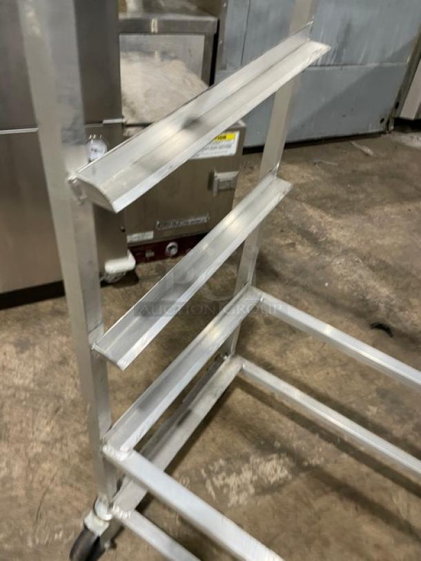 Channel Commercial Aluminum Slanted Display Rack, Model SRS-7, on casters, shows sturdy metal frame, moderate wear.