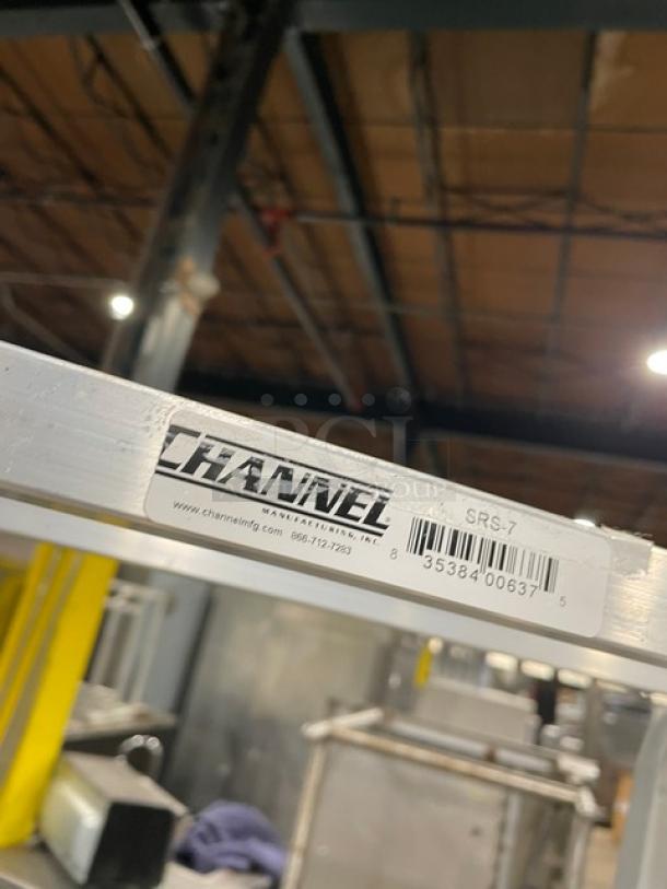 Channel SRS-7 aluminum display rack with slanted shelves and casters, barcode and label shown.