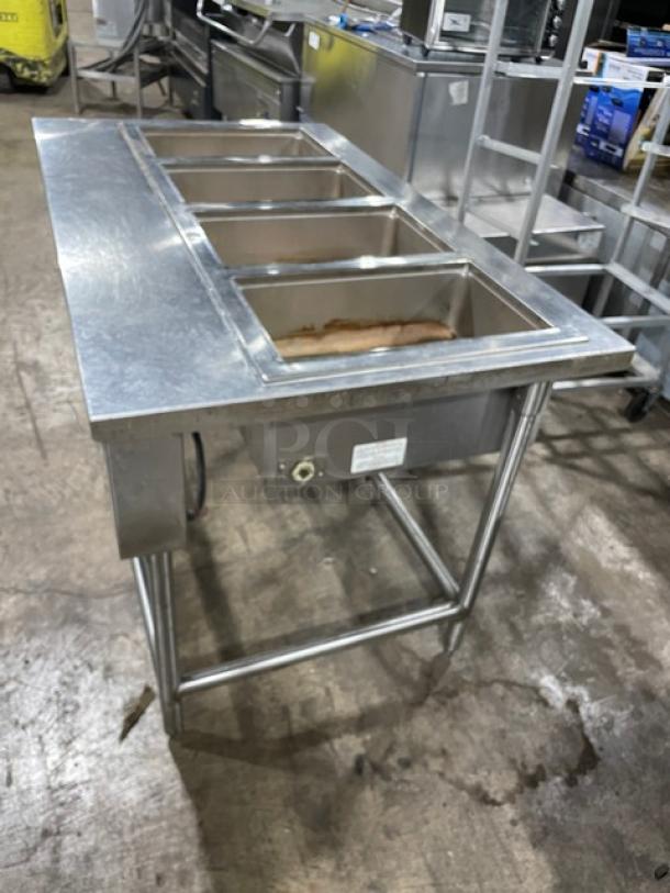 Wells MOD400TDM stainless steel 4-well steamtable on legs, top-mount, electric, model and serial number tag visible.