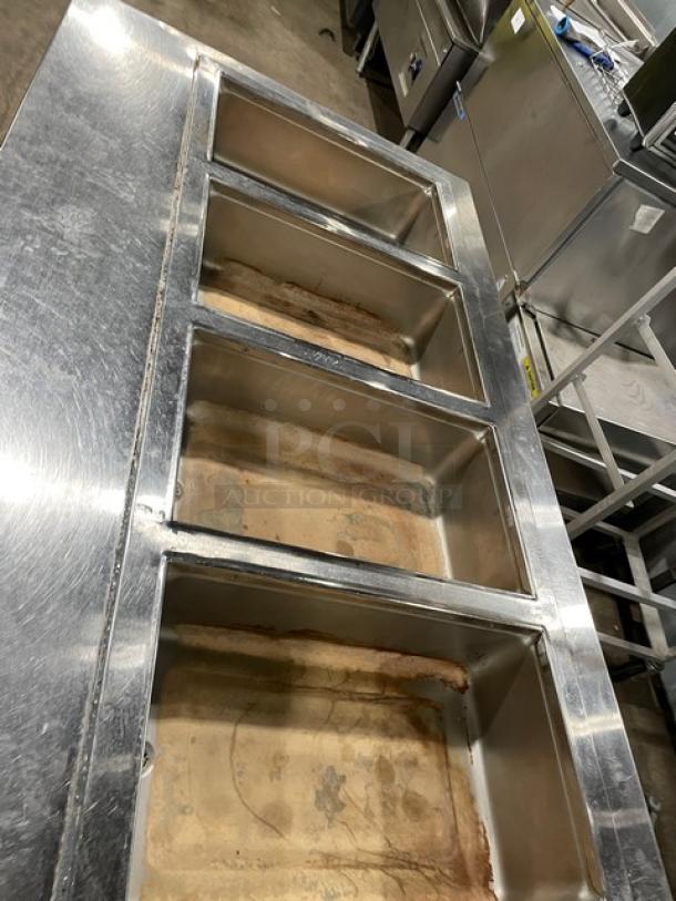 Wells MOD400TDM 4-well stainless steel steamtable, electric, top-mount, on legs, used condition, model and SN visible.