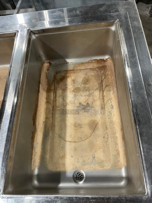 Wells MOD400TDM stainless steel 4-well hot food steamtable, electric, top-mount, on legs, visible wear, 208/240V.