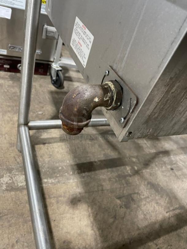 Wells MOD400TDM top-mount 4-well steamtable, stainless steel, electric, on legs. Visible pipe connection, model and serial labels.