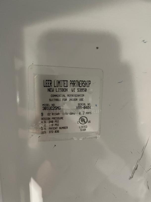 Leer Commercial White Ice Merchandiser, model 301UC25MG, with single glass swing door. Label shows specs: 115V, SN: HAA-0404.