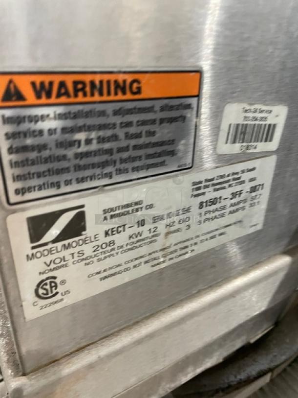 Southbend KECT-10 steam kettle serial tag, showing model, serial number, voltage, and warning label.