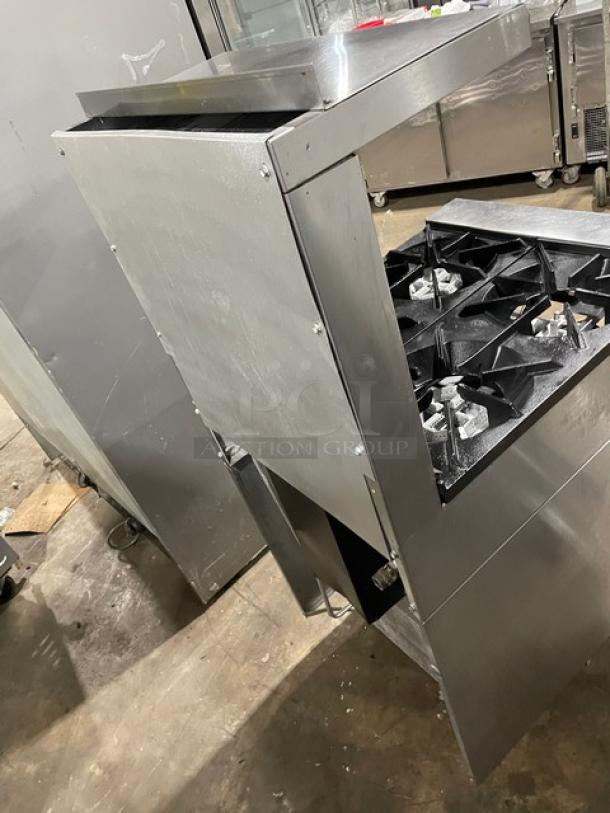 Sunfire commercial stainless steel 4-burner range/oven combo with backsplash, overhead shelf, and wired oven rack, on legs.