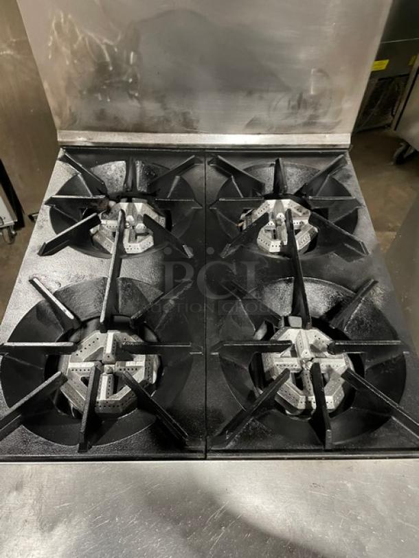 Sunfire stainless steel 4-burner natural gas range/oven combo with backsplash, overhead shelf, and wired oven rack.