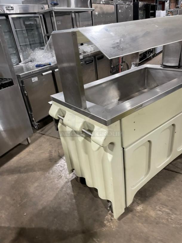 Custom stainless steel portable refrigerated salad bar with sneeze guard, folding tray slide, on casters. Suitable for buffet.