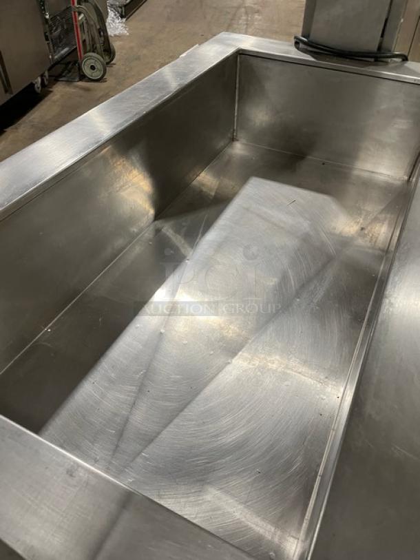 Custom stainless steel refrigerated salad bar with sneeze guard, folding tray slide, and casters. Ideal for buffet use.