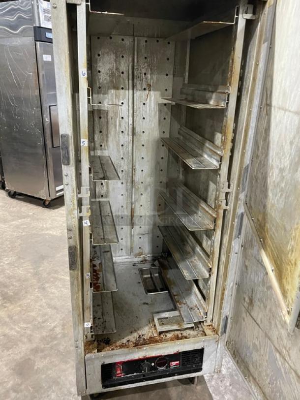 Metro Flavor Hold heated cabinet, Model C199-H1N, with wide pan slides, on casters. Shows interior wear and rust.