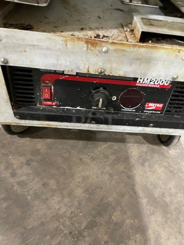 Metro Flavor Hold Series insulated heated cabinet, Model C199H1N, 120V, on casters. Features include wide pan slides and control panel with power switch and thermostat. Used condition.