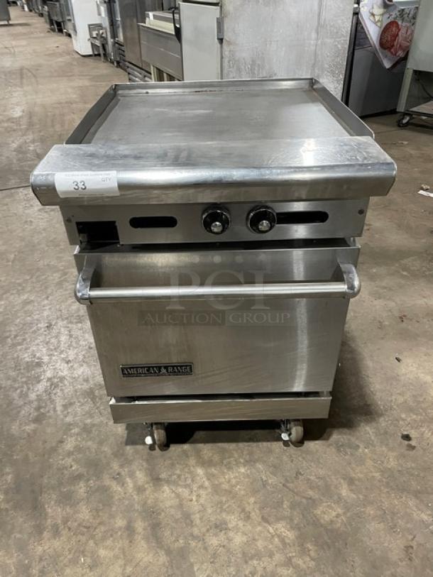American Range 24" stainless steel flat-top range/oven combo, natural gas, wired oven rack, on casters, in used condition.