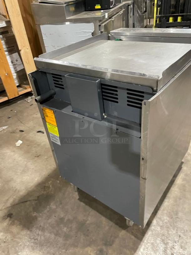 American Range 24" commercial stainless steel flat-top range/oven combo with wired oven rack and casters. Natural gas powered.