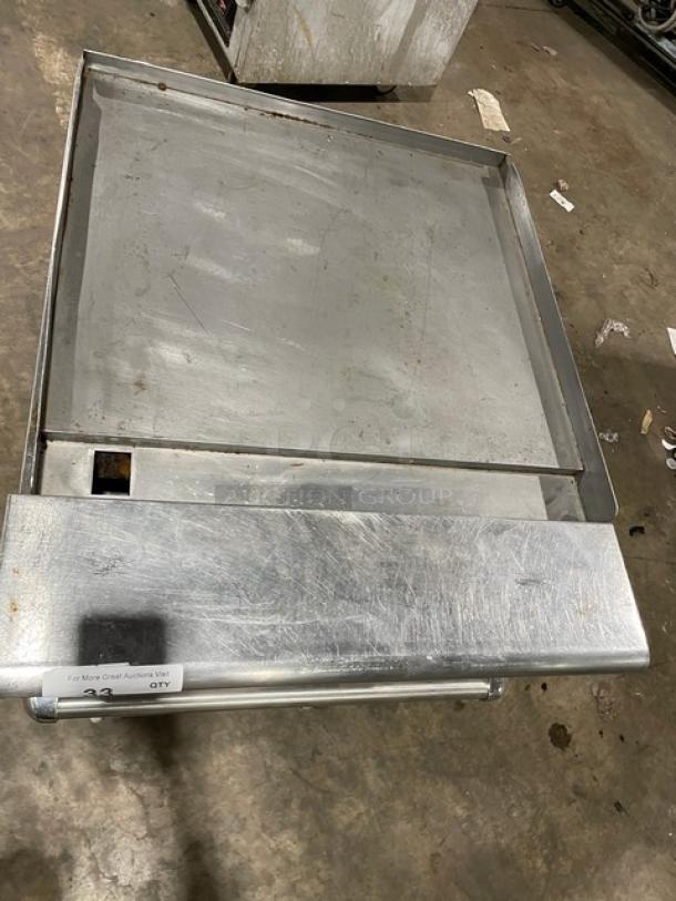 American Range commercial 24" stainless steel flat-top range/oven combo, natural gas powered, with wired oven rack and casters.