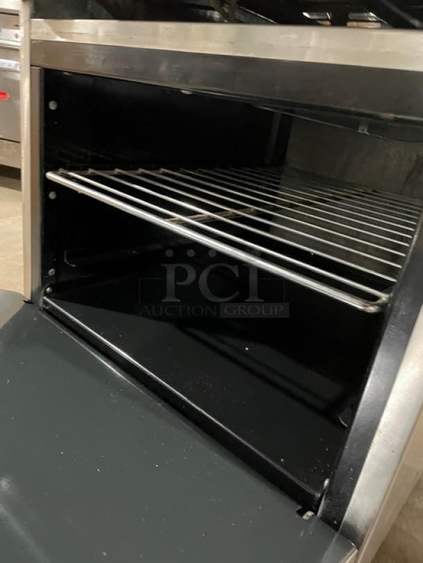 American Range stainless steel 24" flat-top range/oven combo with wired oven rack, on casters, excellent condition.