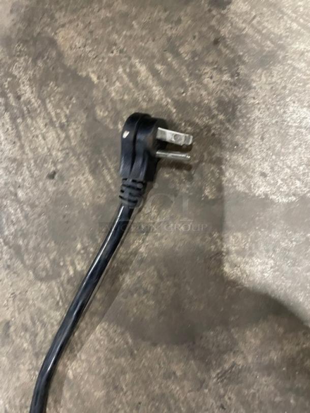 Black power cord for U-Star Commercial Freezer model USFZ-1D, 115V, on concrete surface.