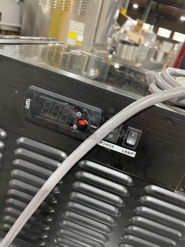 Turbo Air commercial sushi merchandiser with stainless steel interior, rear double sliding doors, temperature controls, and power switches.