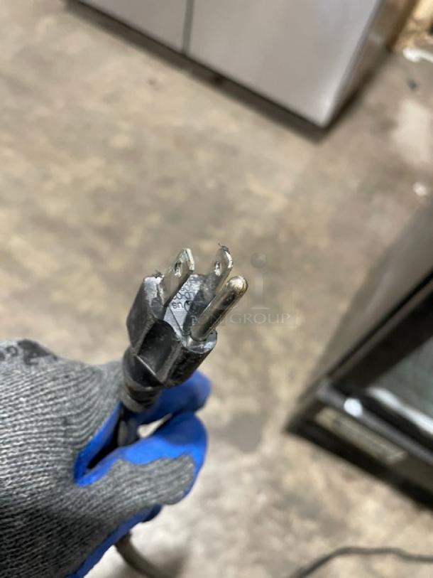 Power plug of Avantco Commercial Single Glass Door Refrigerator, Model 178GDC15HCB, 115V. Plug shows standard three-prong end.