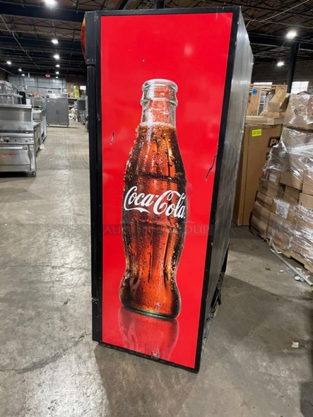 True GDM-49 commercial refrigerator with Coca-Cola style, black double glass swing doors, poly-coated wire rack. 115V, 1 Phase.