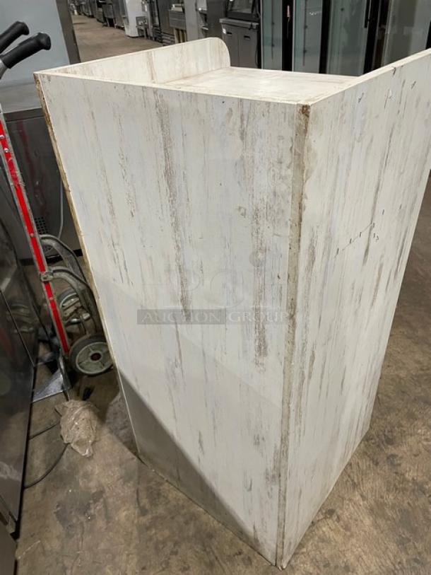 Commercial wooden enclosed-style trash cabinet, white finish, visible wear, sturdy construction. Ideal for waste management.