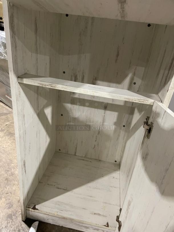 Commercial wooden enclosed-style receptacle waste/trash cabinet, distressed white finish, open door showing interior shelf.