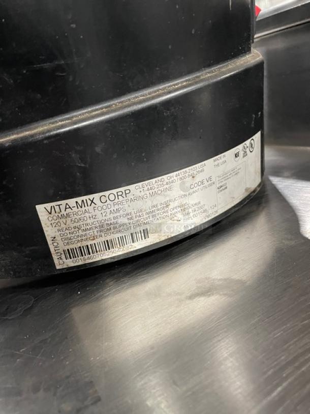 Vita-Mix VM0126 commercial blender, clear polycarbonate container, double insulated hopper, label shows model and serial number.