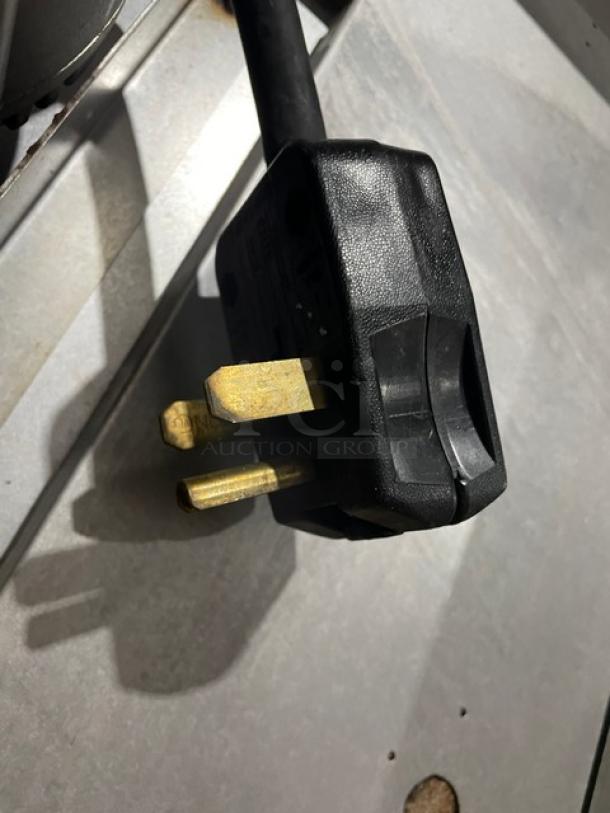 Close-up of a power plug for Blodgett stainless steel electric convection oven. Three-pronged design.