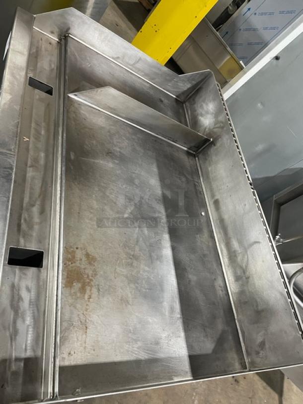 WoodStone 48" stainless steel natural gas plancha griddle with back and side splash, single undershelf cart, on casters.