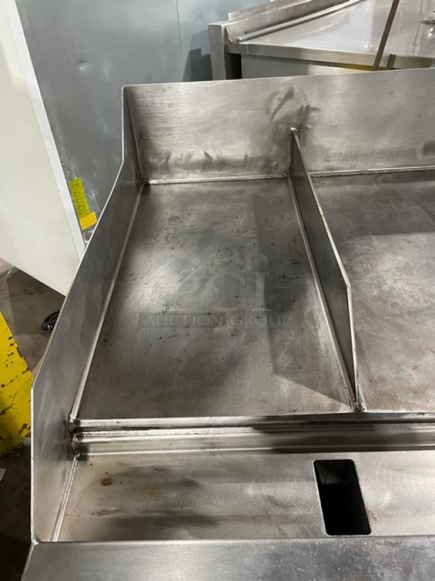WoodStone 48" stainless steel natural gas plancha griddle, includes back & side splash, on casters with undershelf cart.