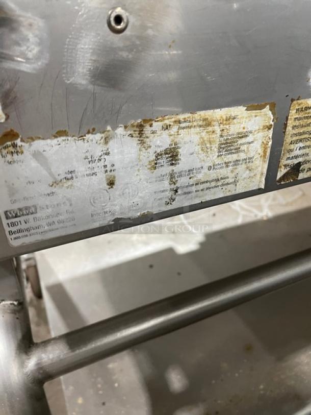 WoodStone commercial 48" stainless steel countertop griddle with back and side splash, undershelf cart, on casters, visible wear.