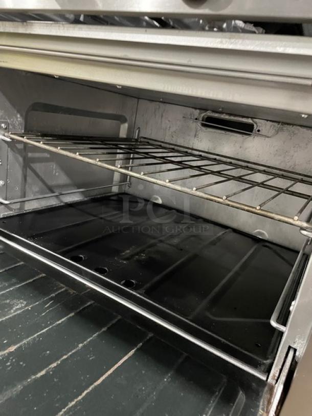 Sunfire by Garland stainless steel 6-burner range/oven with oven racks. Model SX-6-26, SN: 0611100156426, on casters.