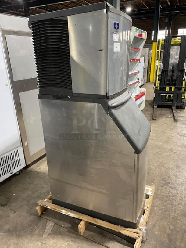 Manitowoc stainless steel ice machine, model IY0524A-161, air-cooled, electric, with legs, shown in industrial setting.
