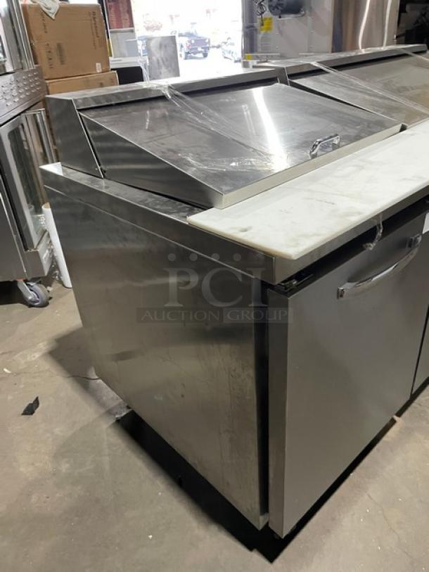 Continental RA93N30M stainless steel refrigerated prep table with cutting board and poly-coated rack. Model RA93N30M, on casters.