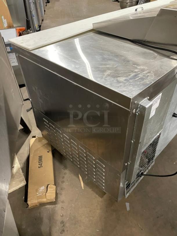 Continental stainless steel refrigerated prep table, model RA93N30M, with 3-1/2 doors, cutting board, and poly coated rack.