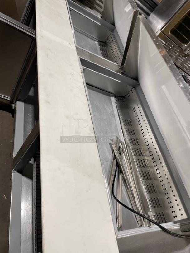 Continental stainless steel 3-1/2 door refrigerated bain marie prep table, Model RA93N30M, with cutting board and poly-coated rack.
